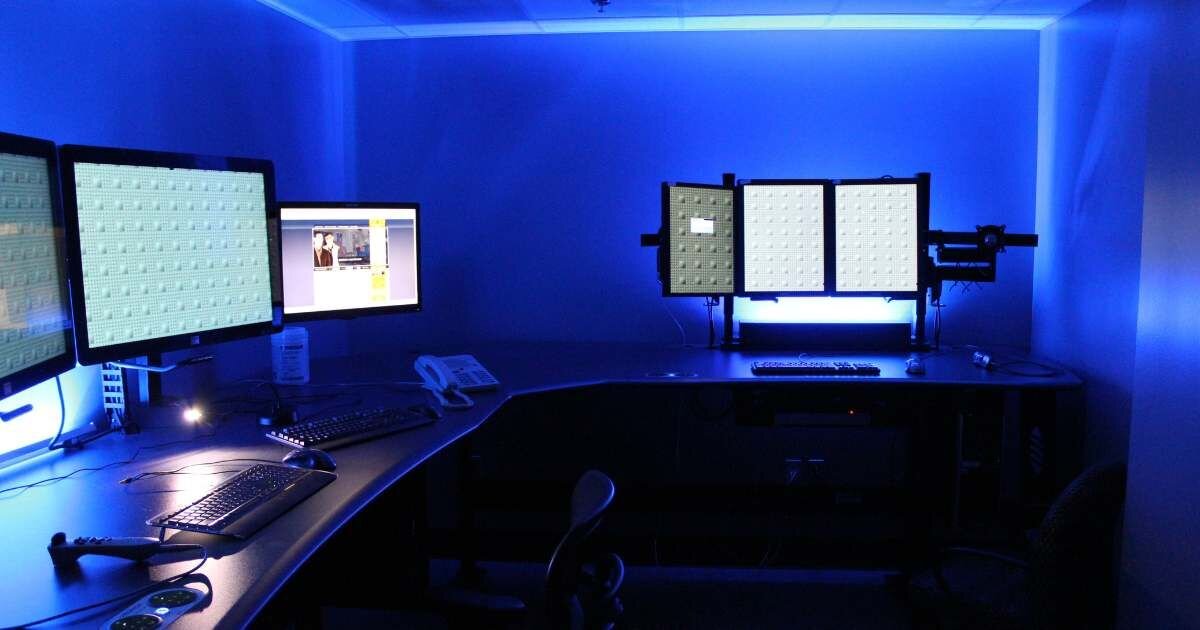 dark office workstations with blue light background